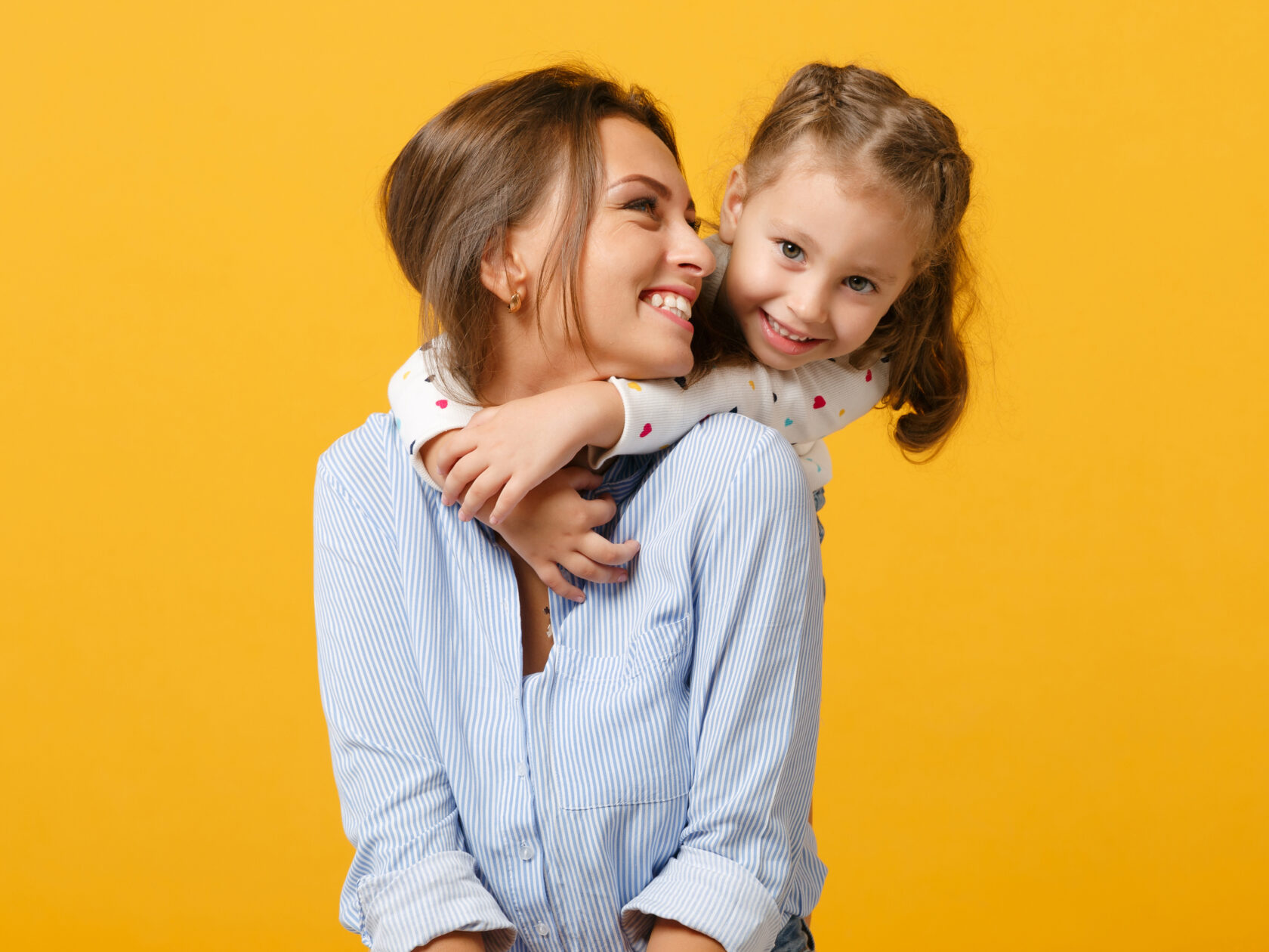 Woman in light clothes have fun with cute child baby girl 4-5 years old.